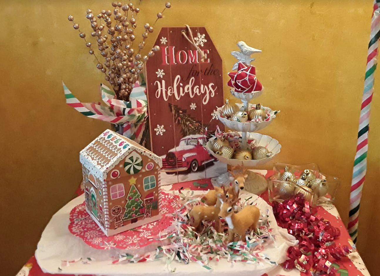 A festive table with a gingerbread house and lights