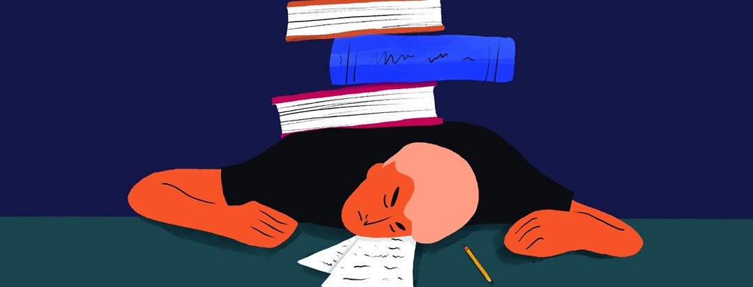 exhausted student laying on a desk with a pile of books on their back