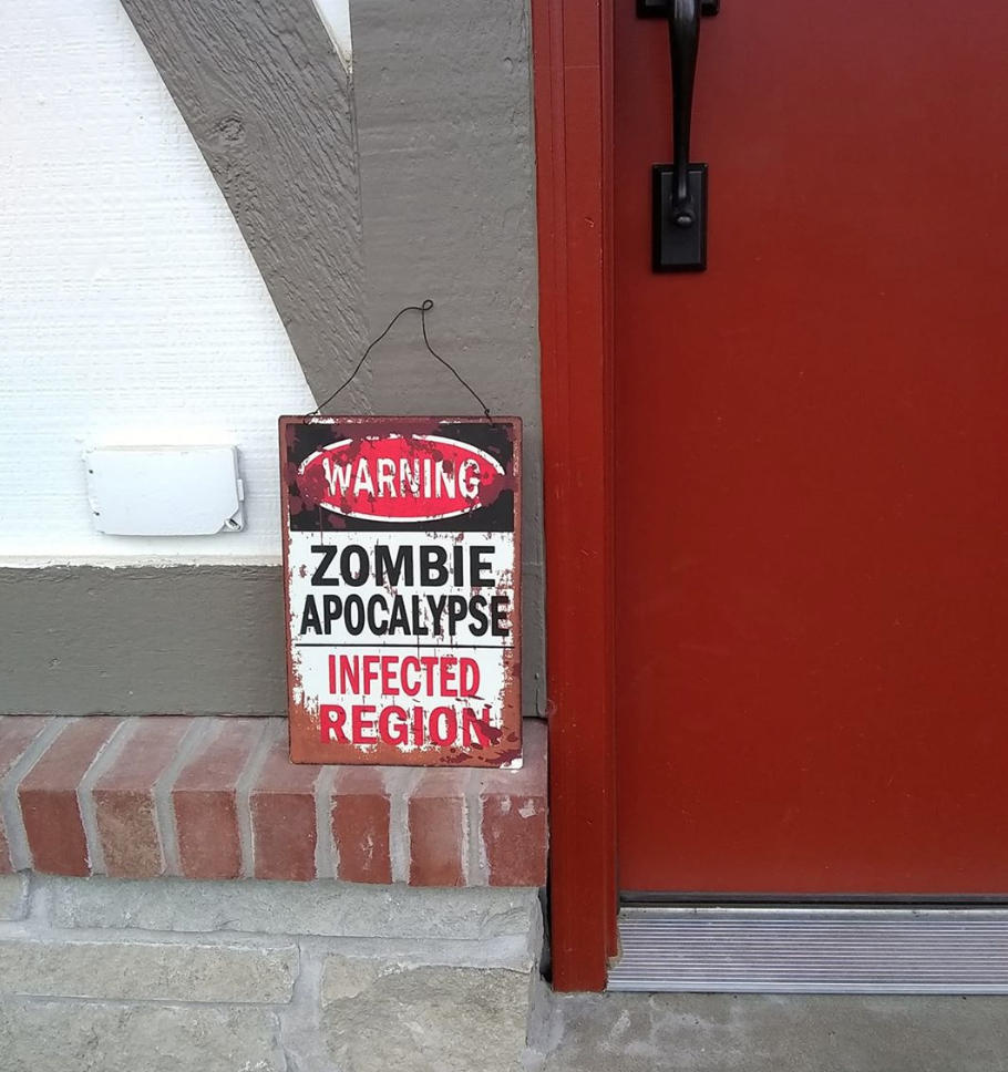 A sign that says Warning! Zombie Apocalypse Infected Region