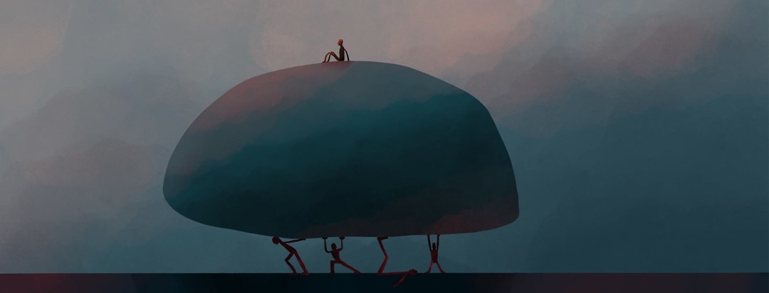 people carrying a giant rock with a person sitting on top of it