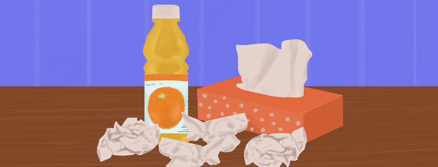 A box of tissues and orange juice on a table.